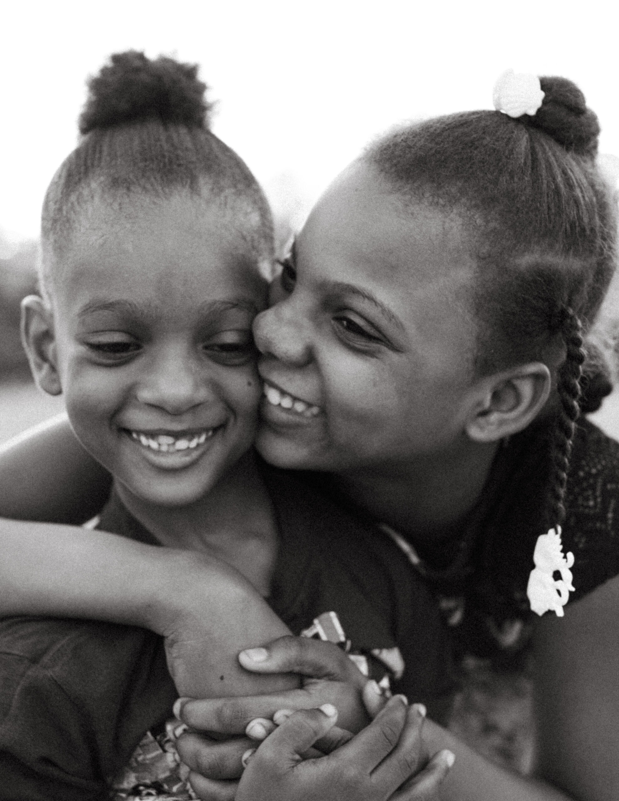International Humanitarian Photographer Two Haitian children embrace in Port-au-Prince, Haiti