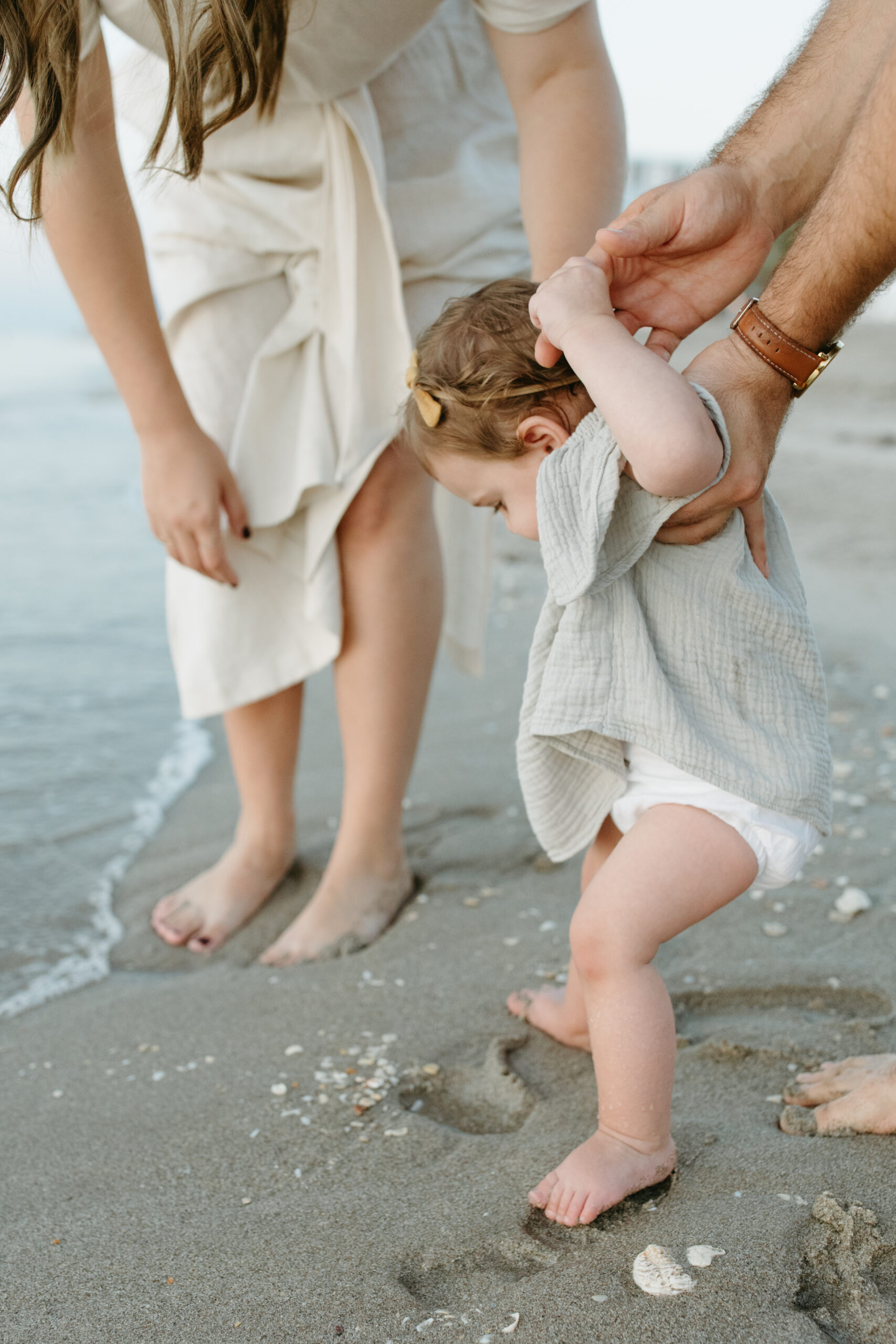 Motherhood and Family Photographer Lauren Neal Photography Family walks on the beach at sunrise in Fort Lauderdale, Florida