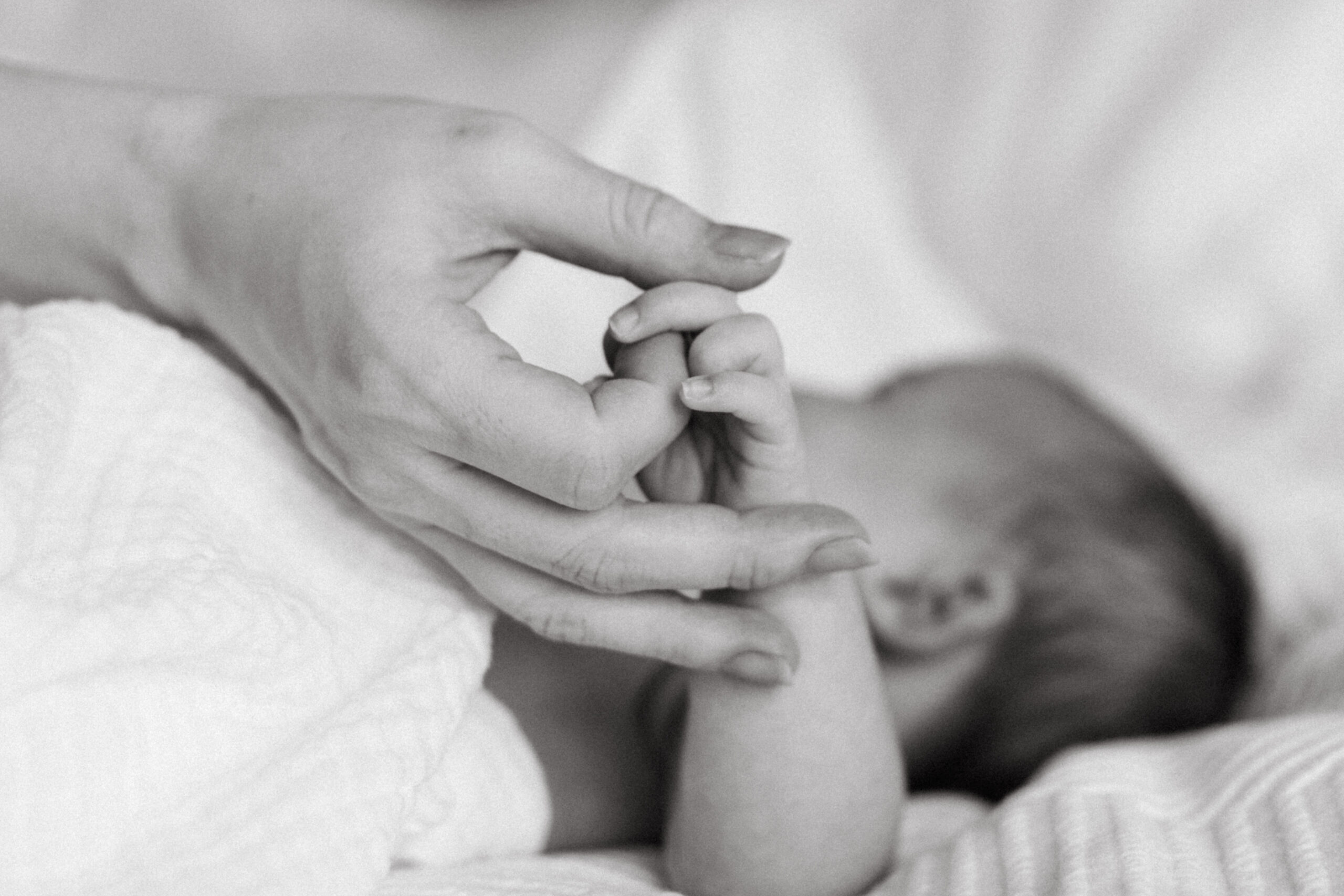Mother holds her infant daughter's hand in Frederick, Maryland