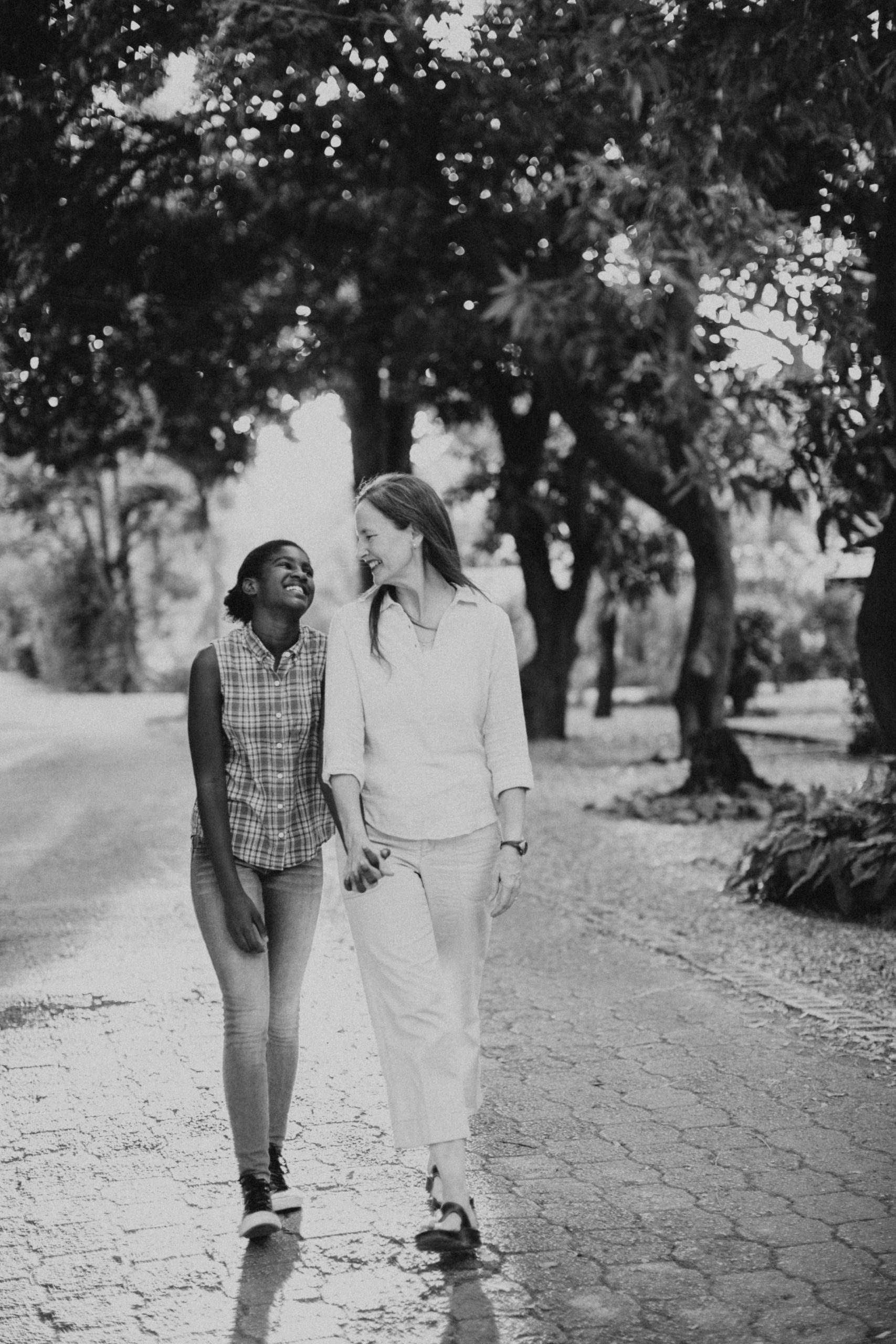 Adoptive family Haiti Lauren Neal Photography Adopted mother holds her daughter's hand while walking in Haiti