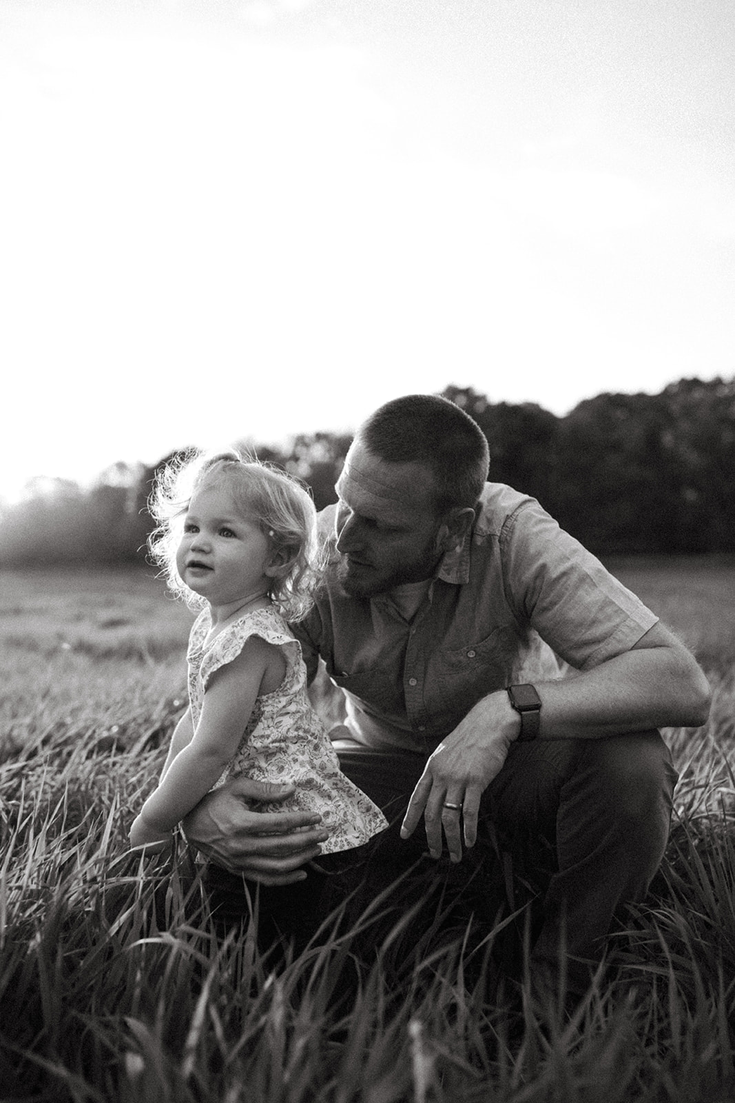 Family and Motherhood Photographer Lauren Neal Photography Father holds his young daughter outside of Minneapolis, Minnesota