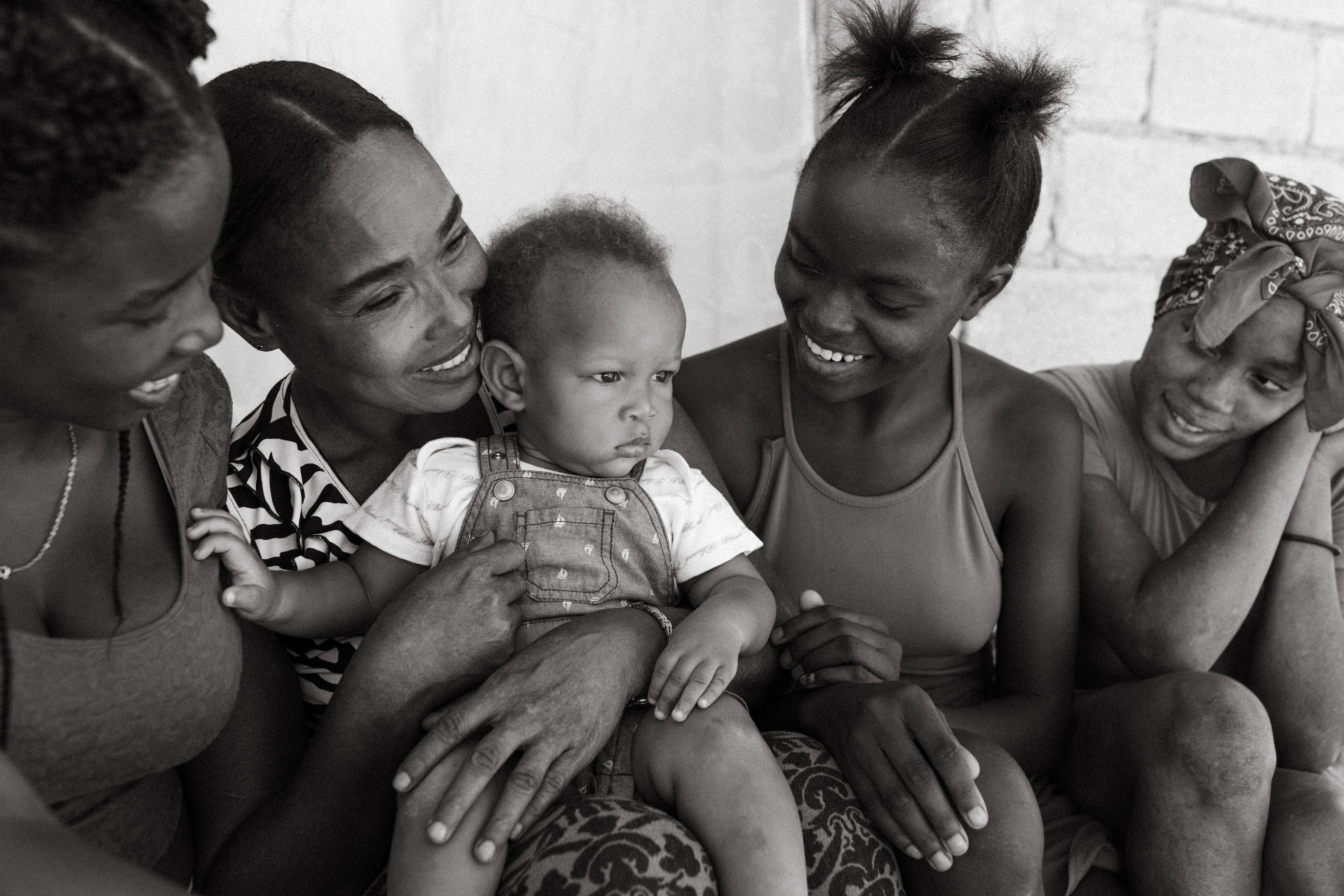 Haitian family with single mom holds a baby in Port-au-Prince, Haiti