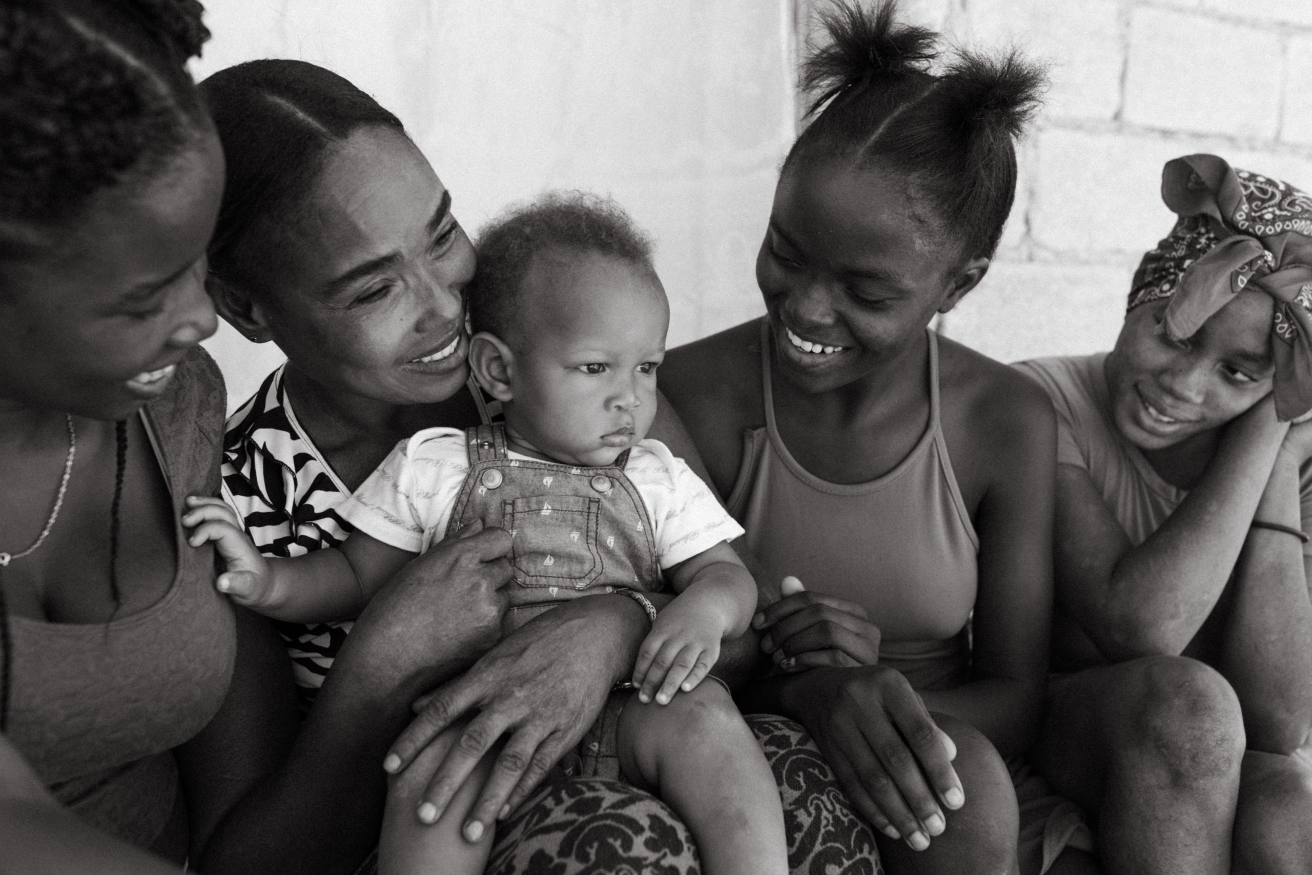 Haiti Humanitarian Photographer Lauren Neal Photography Haitian family with single mom holds a baby in Port-au-Prince, Haiti