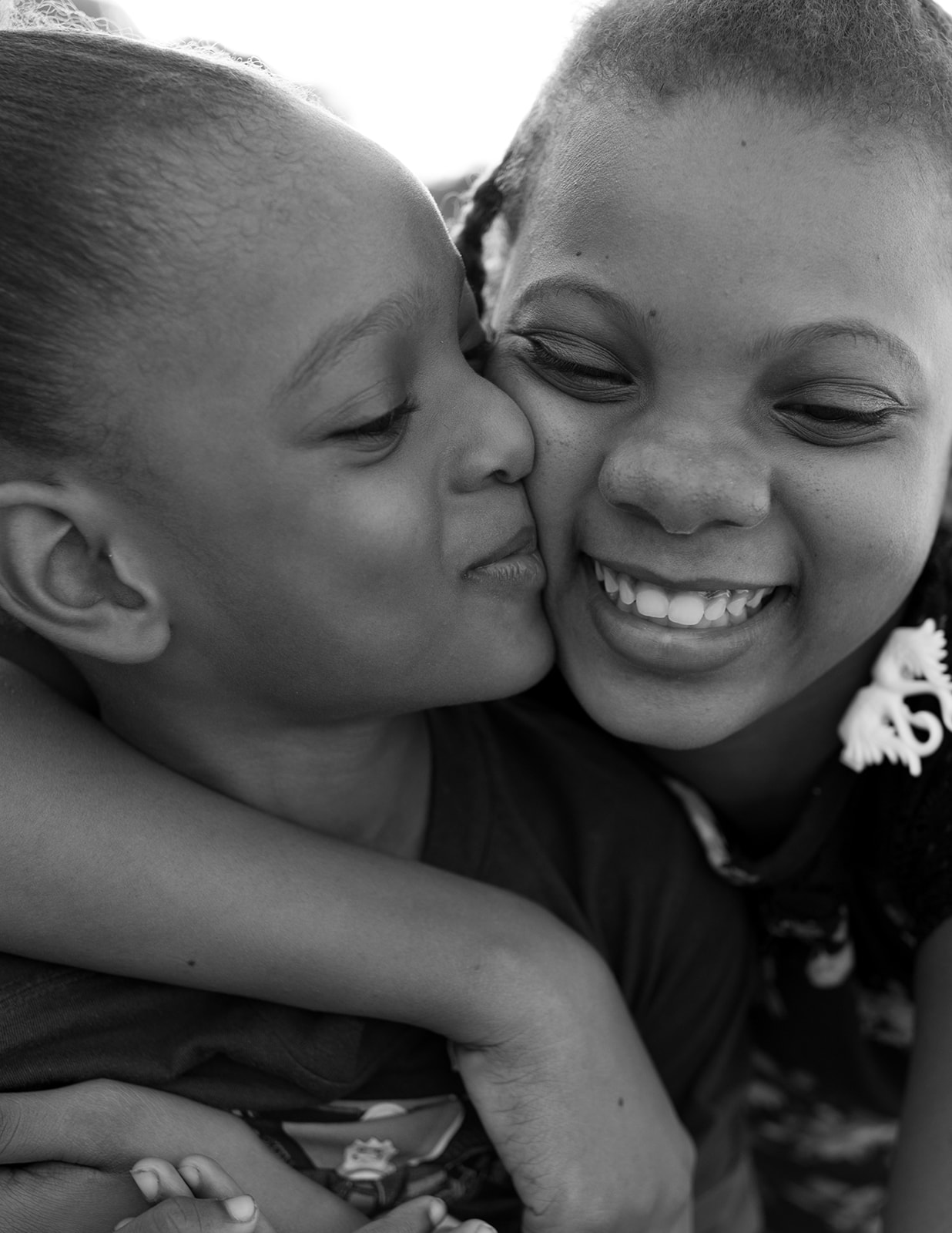 International Humanitarian Photographer Two Haitian children embrace in Port-au-Prince, Haiti
