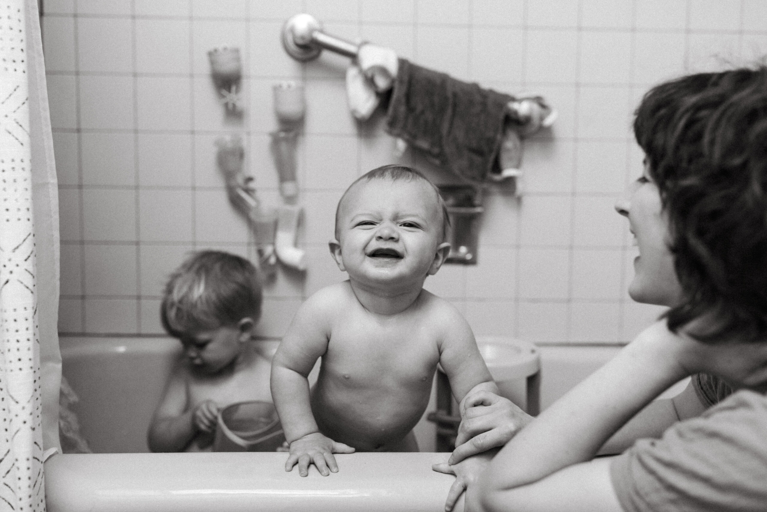 Family and Motherhood Photographer Lauren Neal Photography Two boys play in the bath while their mother watches in Cincinnati, Ohio
