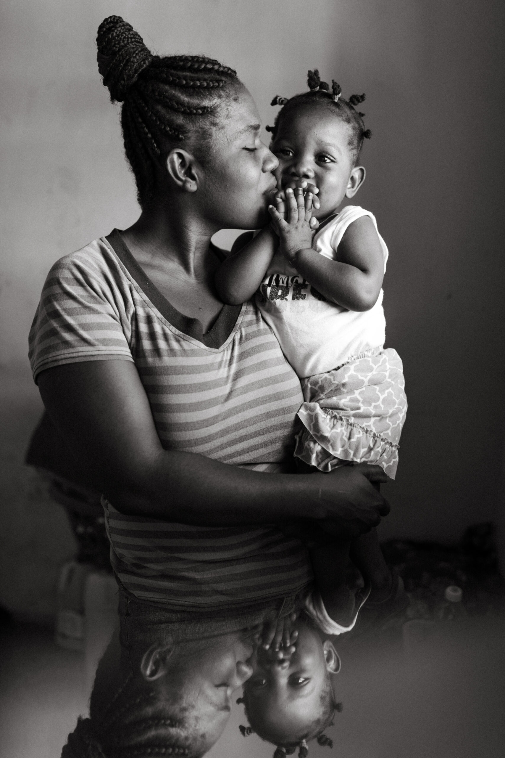 Haitian woman holds her child in Port-au-Prince, Haiti