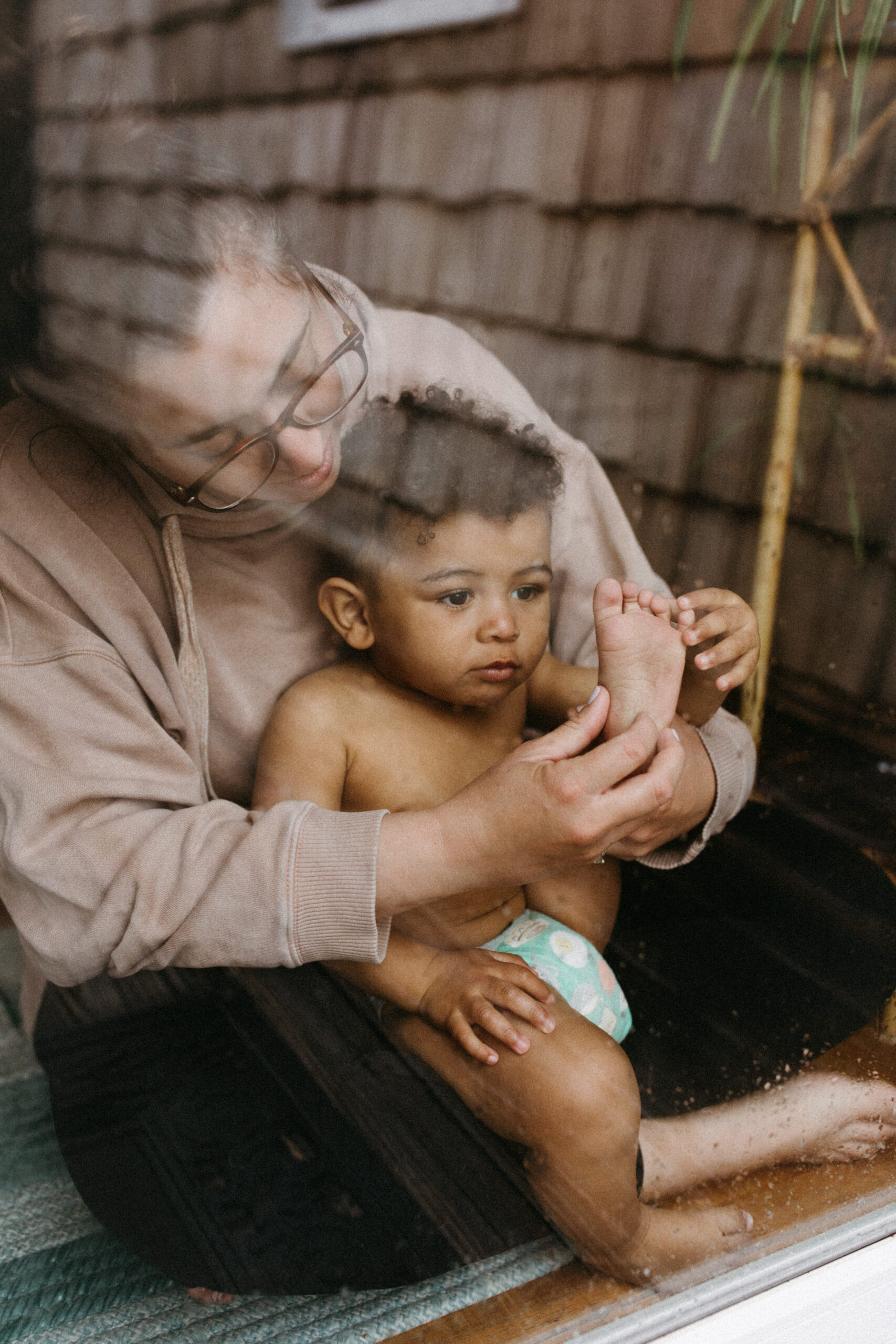 Mother holds her son in her lap in New York