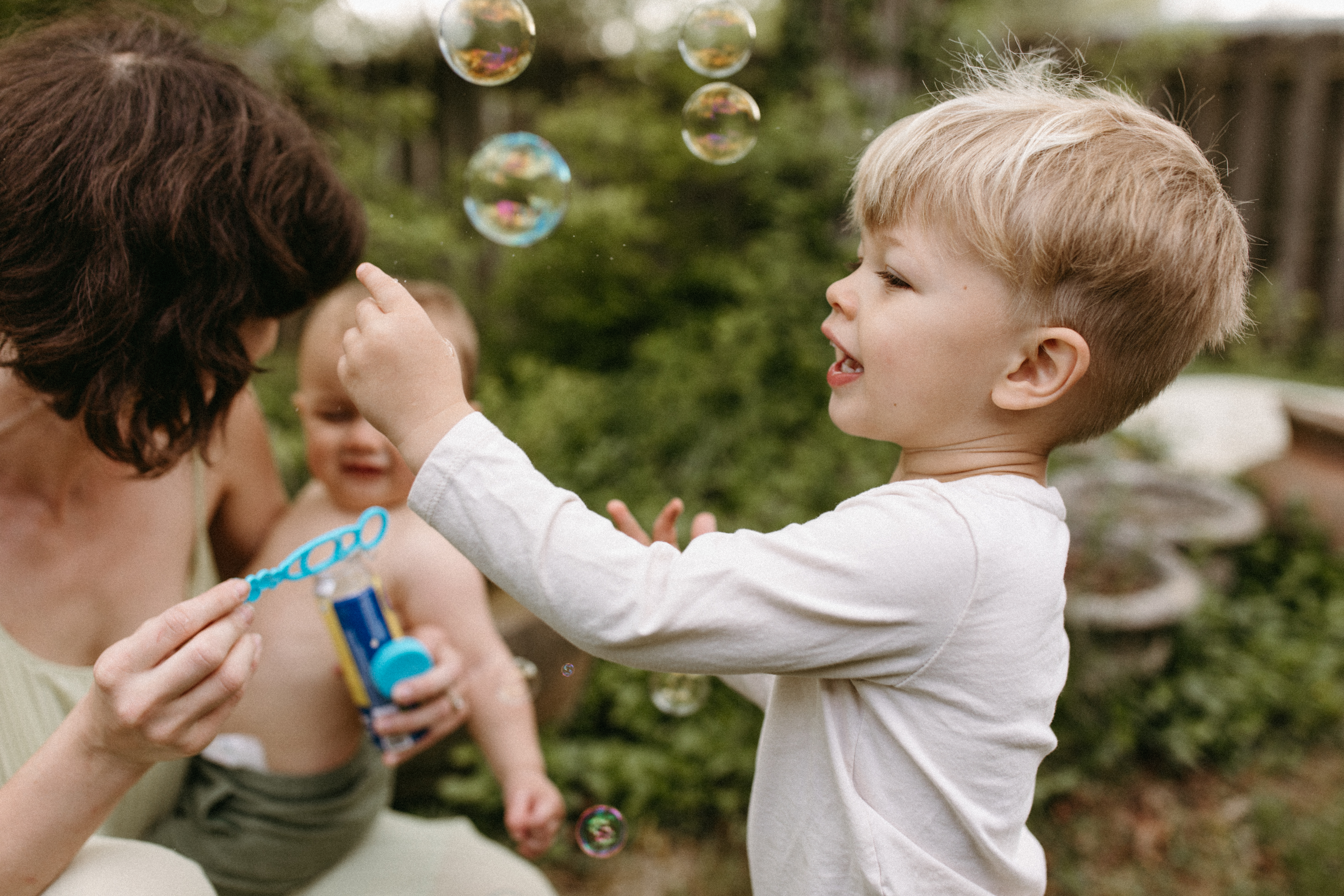 Mother blows bubbles with her children in Cincinnati, Ohio