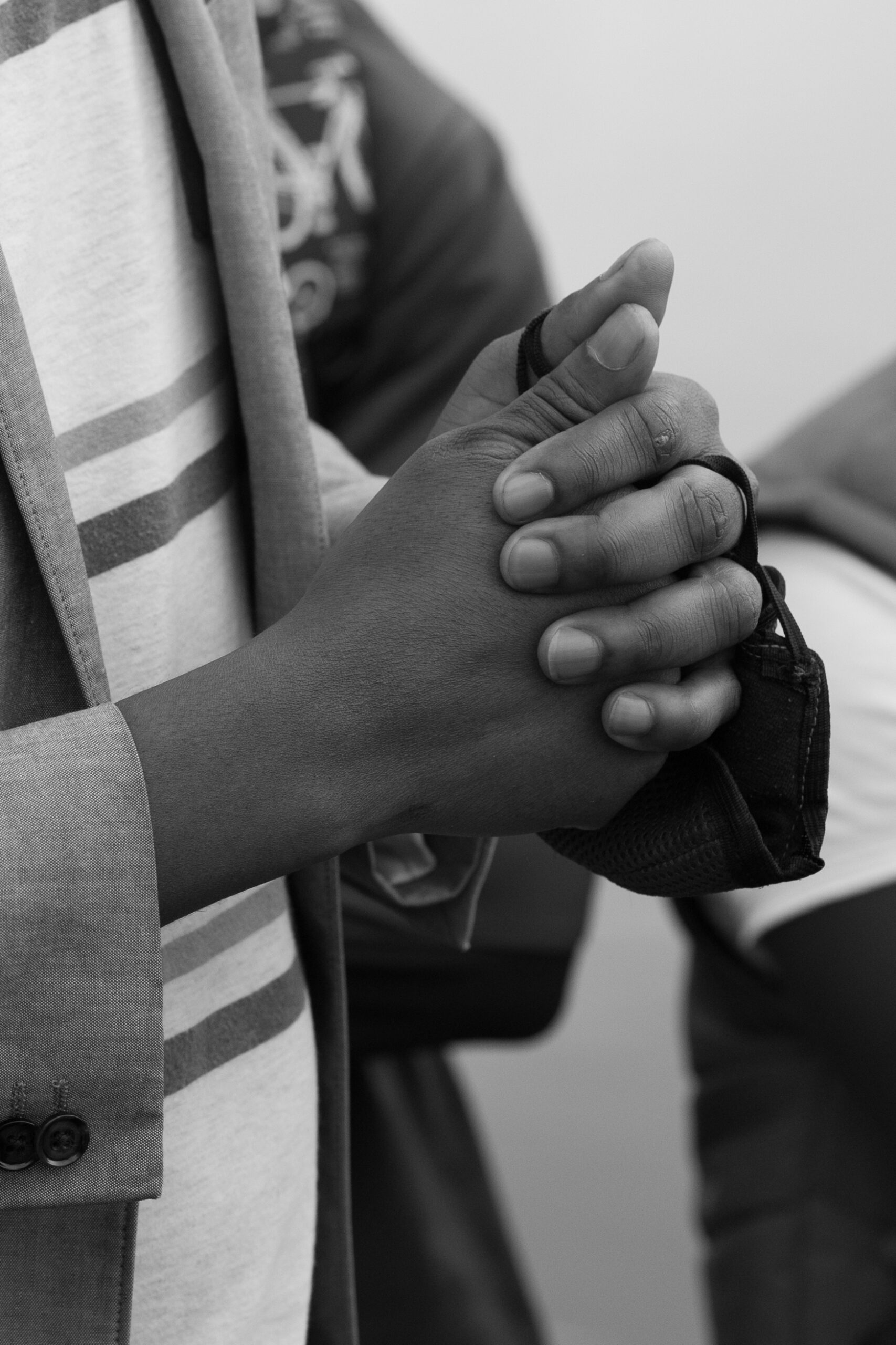 A Haitian man clasps his hands together while recounting his story through the Darien Gap to get to the US Mexico border