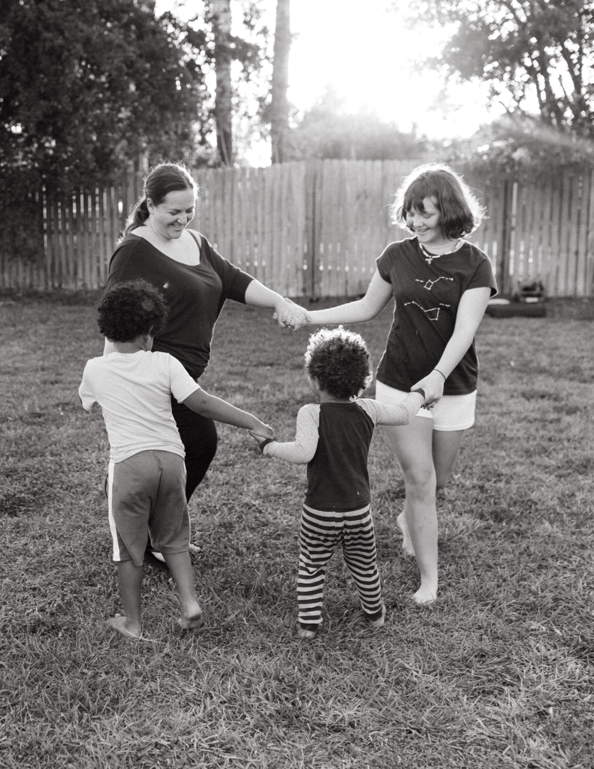 Mother plays with her children in the yard in Venice, Florida