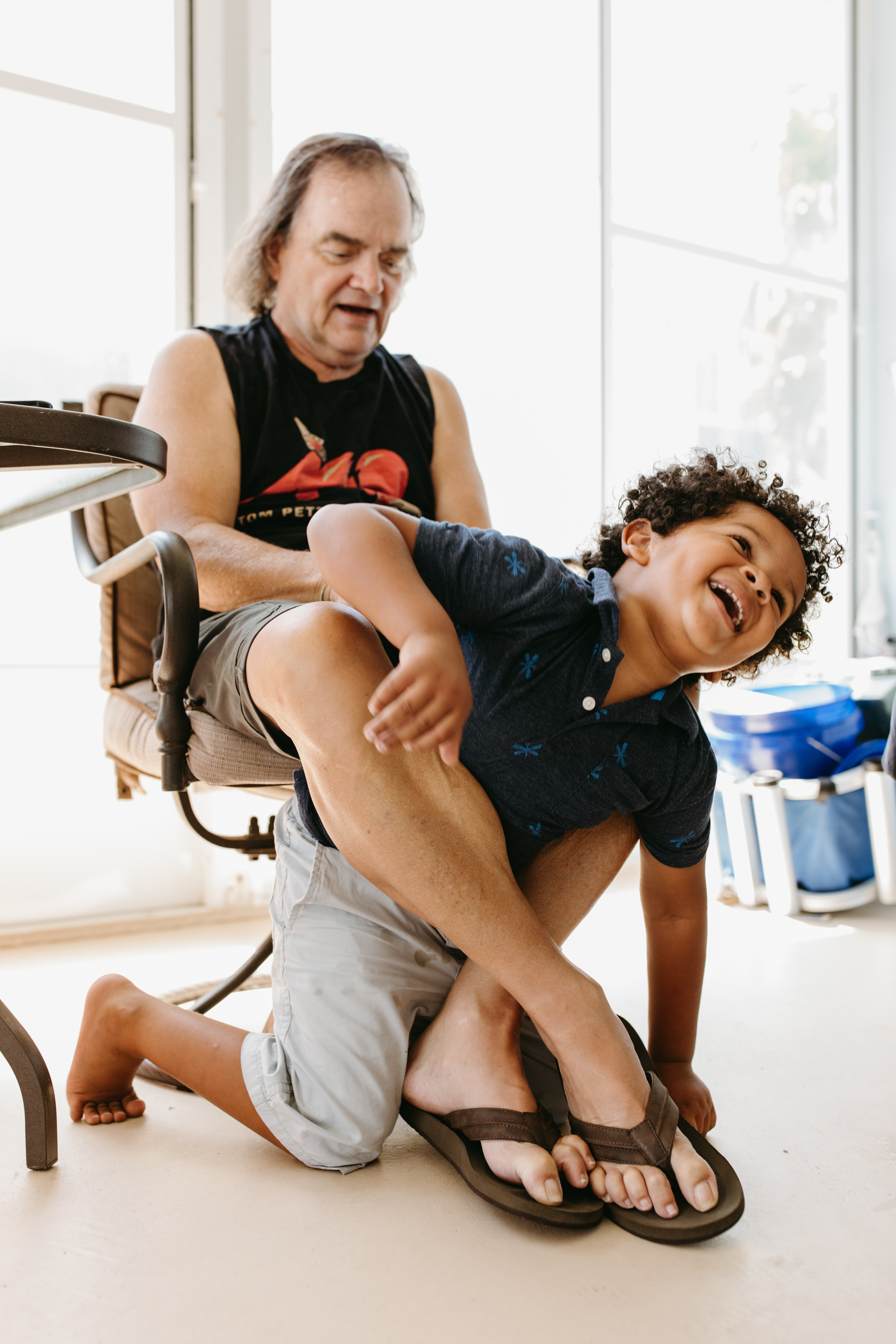 Lifestyle Family Photographer from Cincinnati, Ohio Grandfather holds his grandson in Venice, Florida
