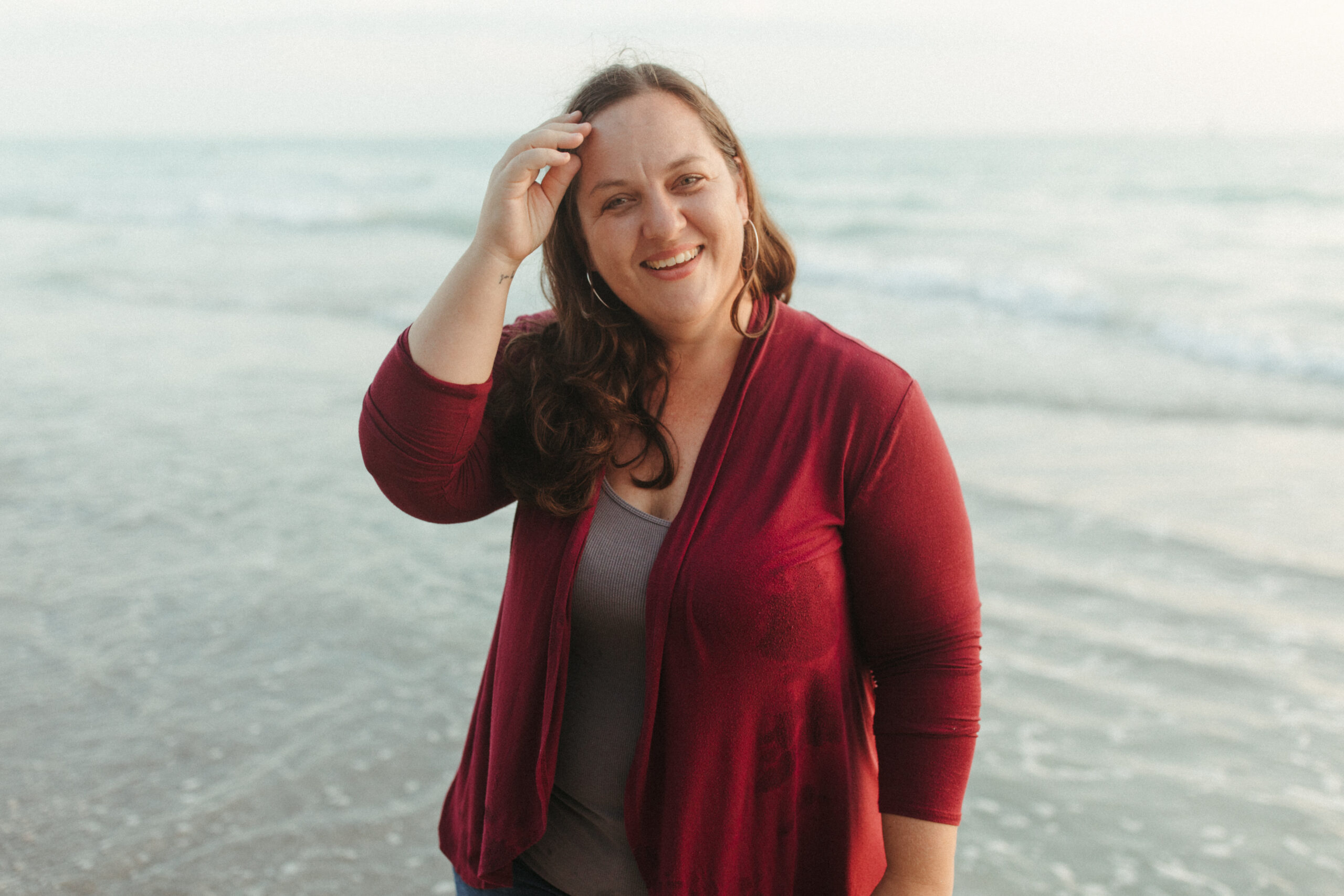 Woman stands by the ocean in Venice Beach, Florida