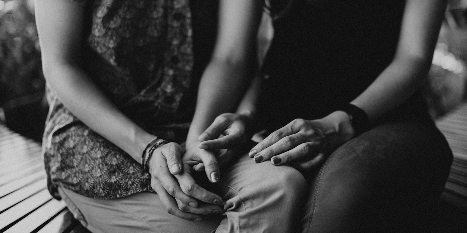 Engaged mixed couple holds hands in Bangkok, Thailand