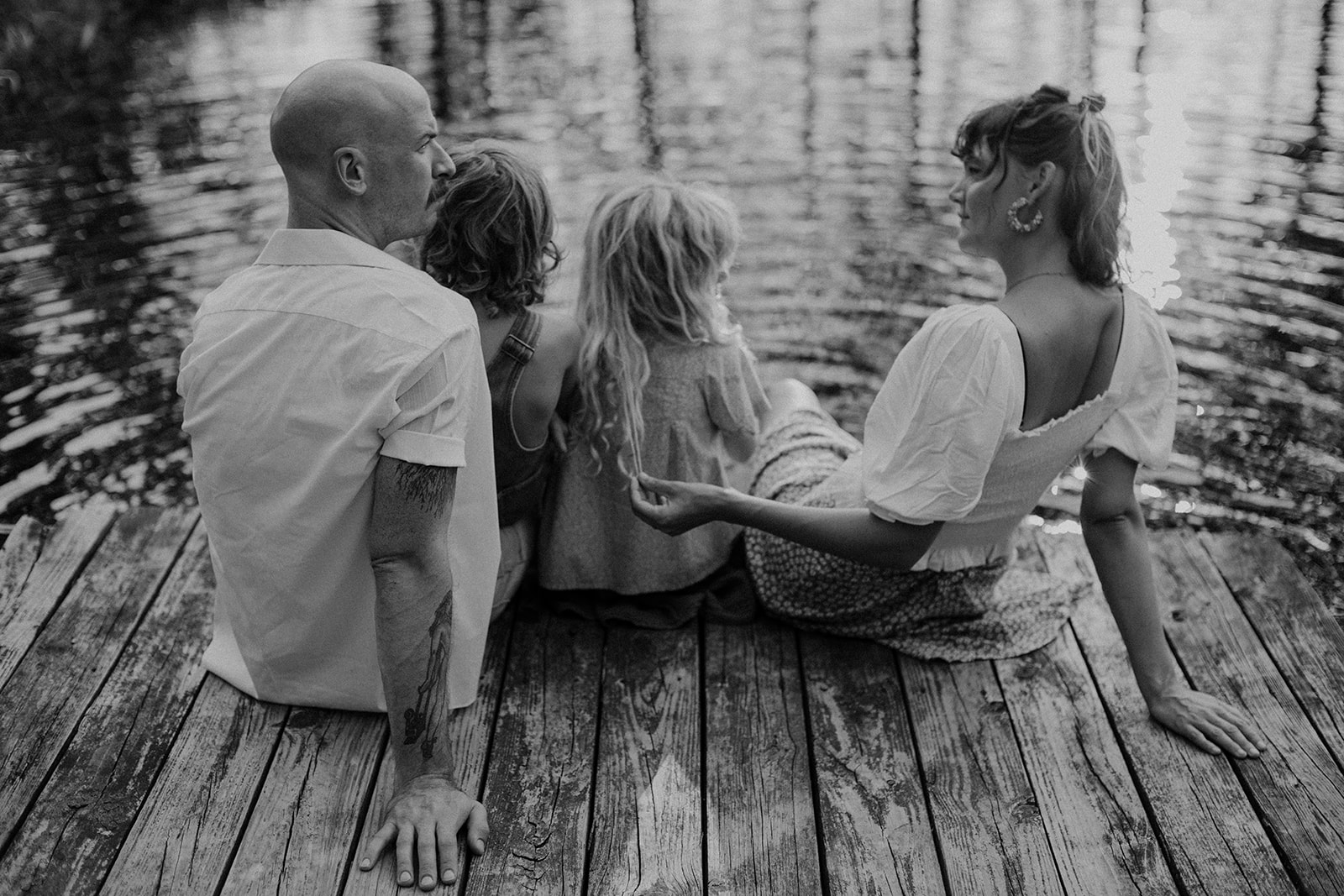 Family sits by on the dock on their family farm in Cincinnati, Ohio