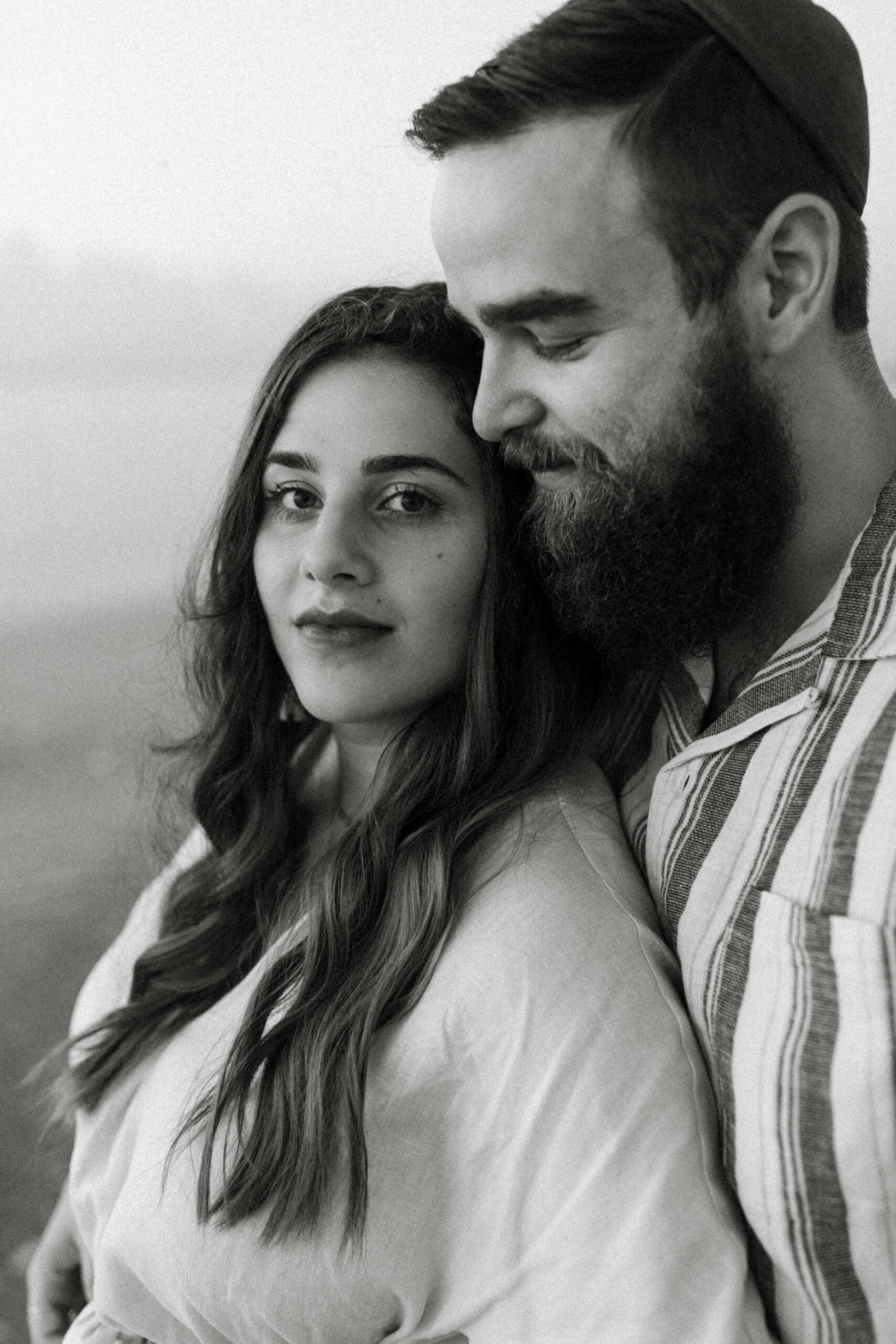 Family and Motherhood Photographer Lauren Neal Photography Jewish couple embraces on the beach in Miami, Florida