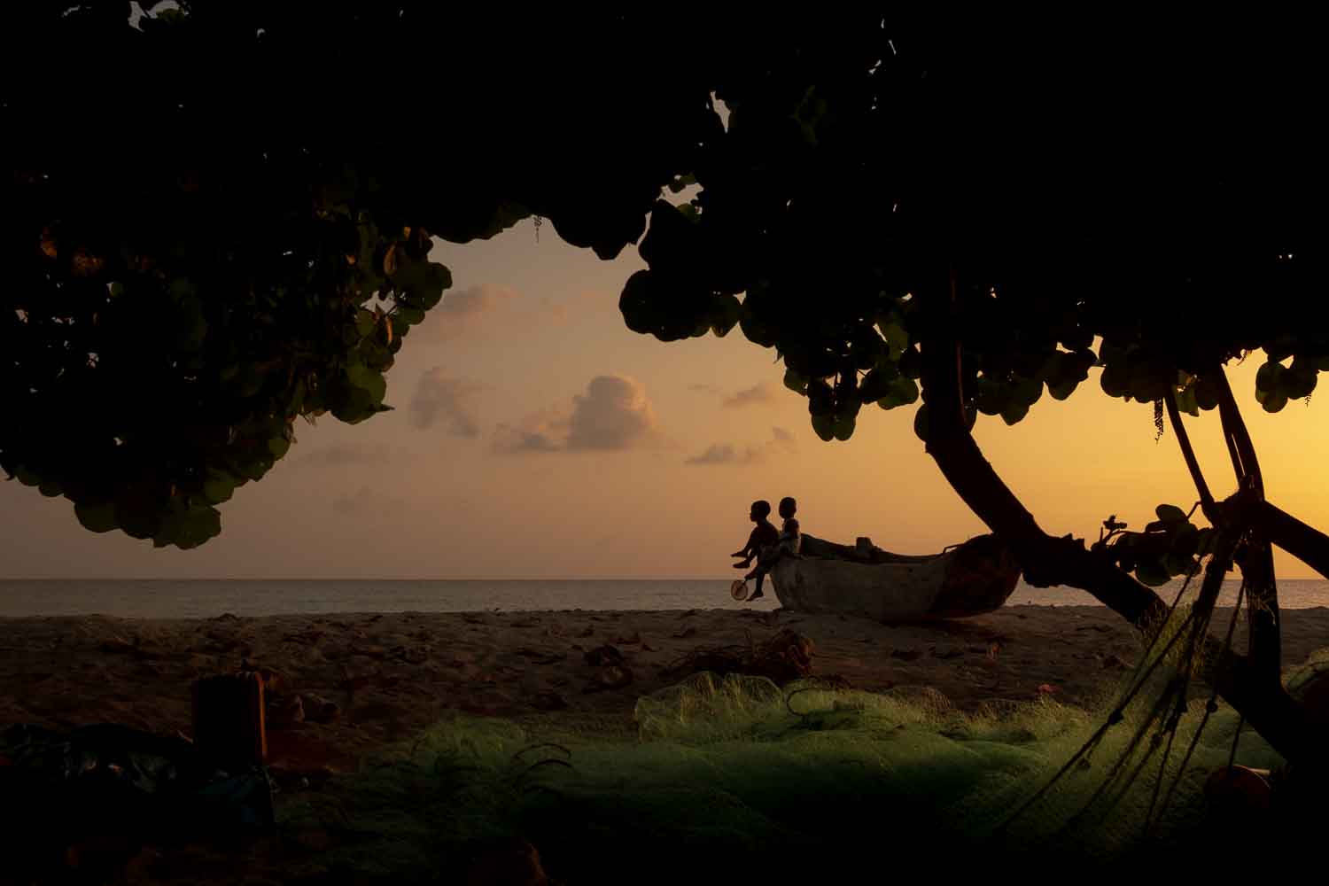 haitian-boys-fishing-boat-shoreline Two children lay on their mother's lap in Cincinnati, Ohio